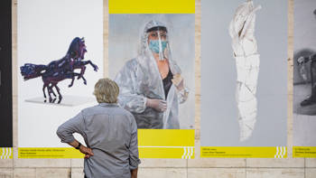 A person looks at the event posters at the Lincoln Center
